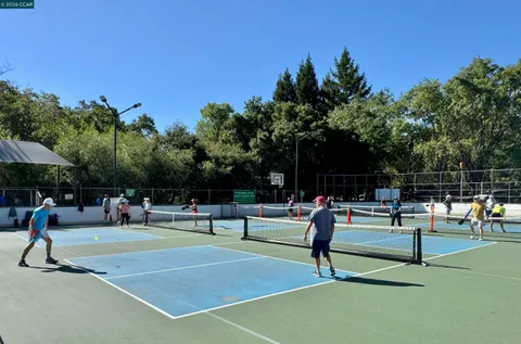 a view of a park with swings and slides