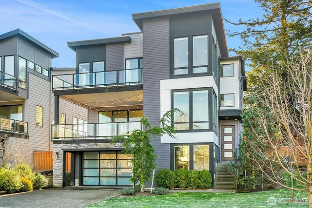 a front view of a residential apartment building with a yard