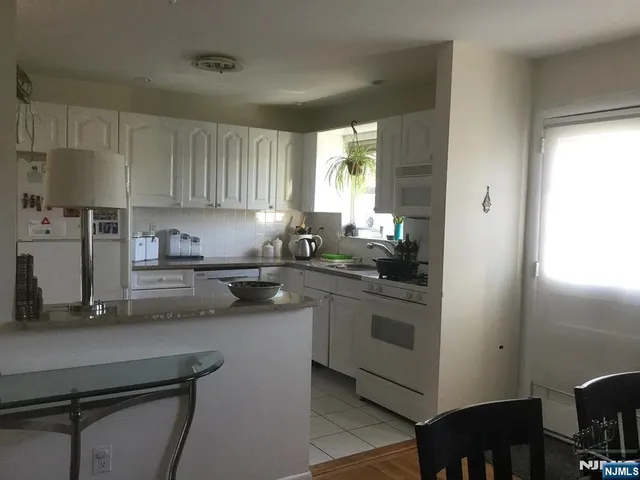 a kitchen with a sink cabinets and window