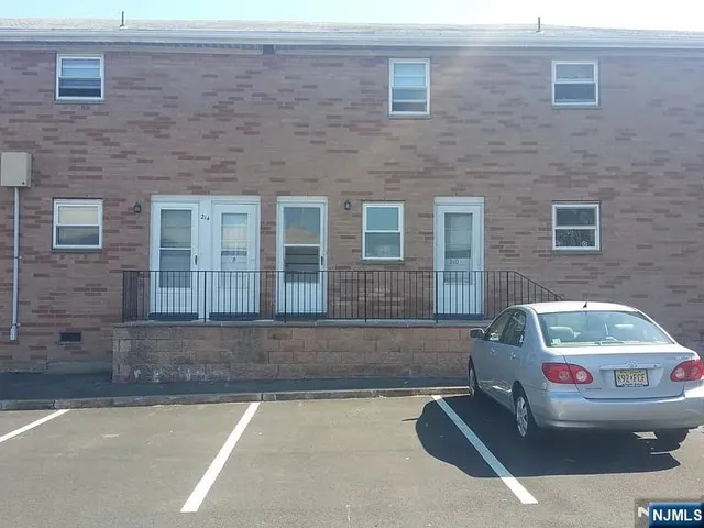 a front view of a house with parking space