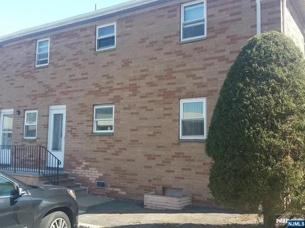 a brick building with a yard