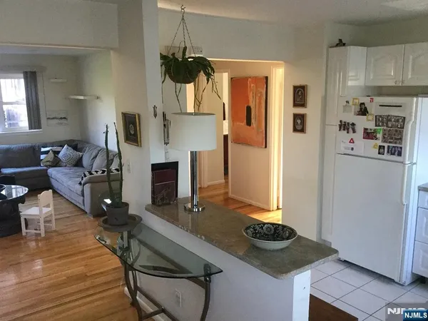 a living room with furniture a fireplace and kitchen view