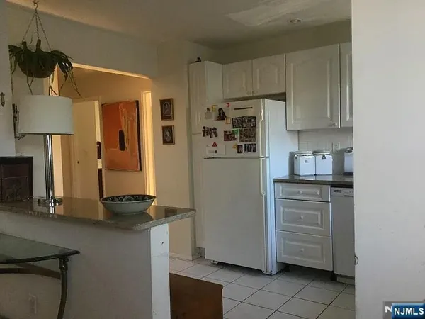 a kitchen with stainless steel appliances granite countertop a refrigerator and a stove