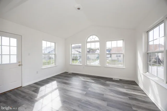 a view of a kitchen with a sink and wooden floor