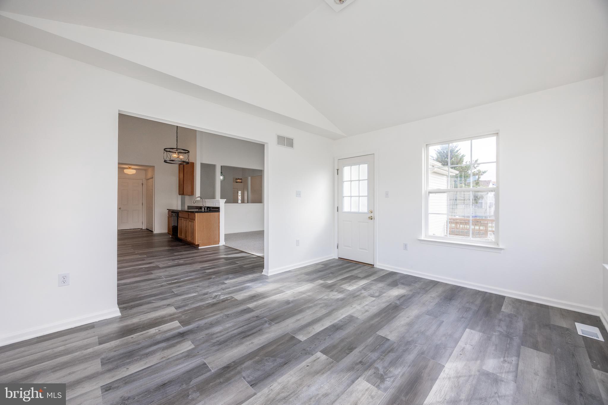 97 Needham Drive Smyrna, DE 19977 - Photo 12 of 52 a view of empty room with wooden floor and fan