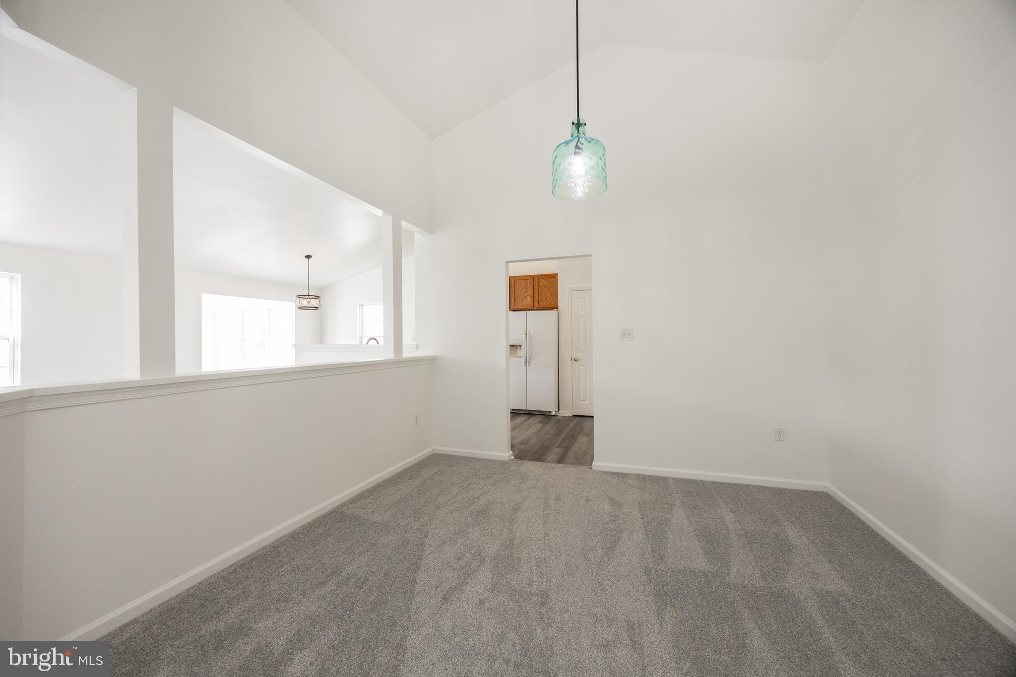 97 Needham Drive Smyrna, DE 19977 - Photo 20 of 52 a view of an empty room with window and chandelier fan