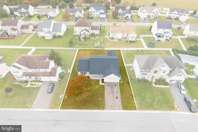 a view of a room with wooden floor and white walls