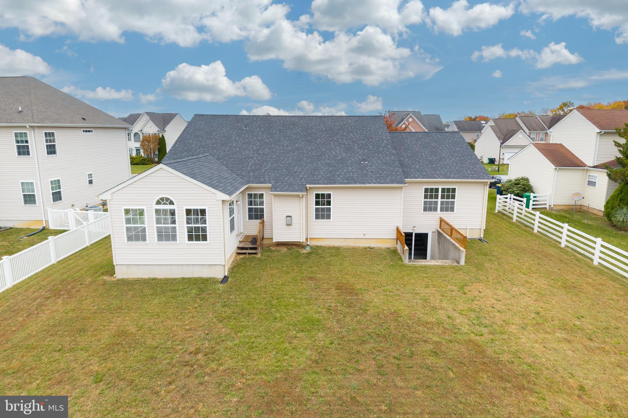 97 Needham Drive Smyrna, DE 19977 - Photo 4 of 52 a view of a house next to a big yard with potted plants