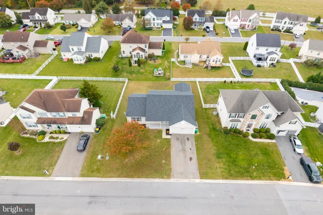 a aerial view of a house with swimming pool and furniture