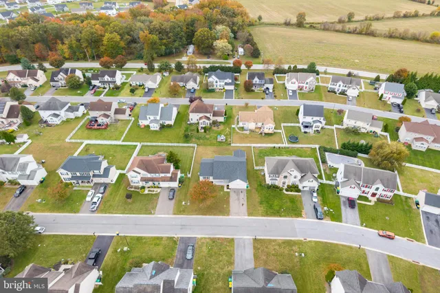 an aerial view of residential houses with outdoor space and swimming pool