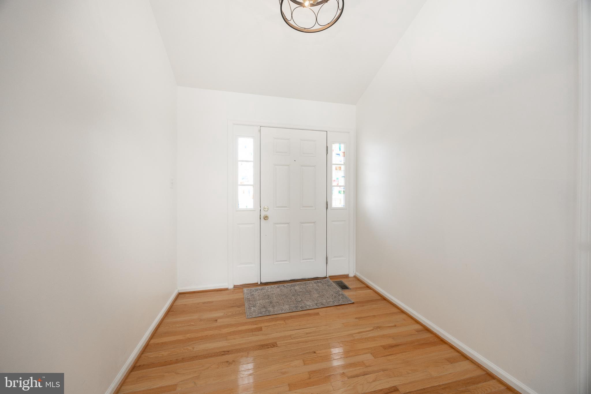 97 Needham Drive Smyrna, DE 19977 - Photo 5 of 52 a view of a room with wooden floor and white walls