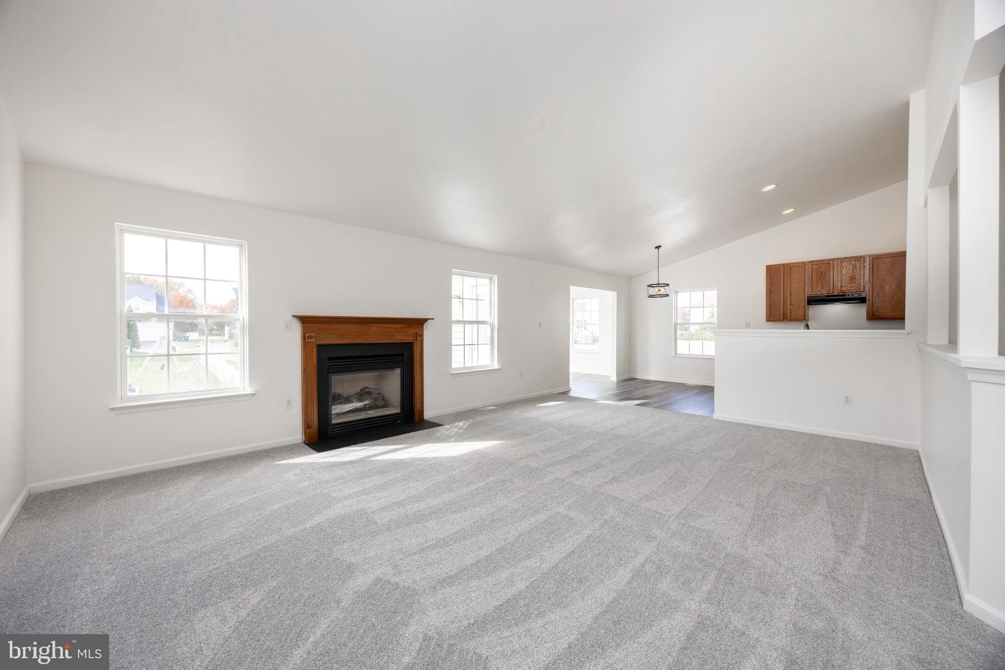 97 Needham Drive Smyrna, DE 19977 - Photo 8 of 52 a view of an empty room with a window and fireplace
