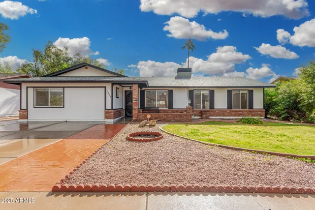 a view of a house with swimming pool and sitting area