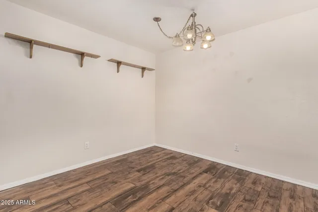 a view of a room with wooden floor and chair