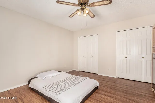 a view of a bedroom with wooden floor and bedroom