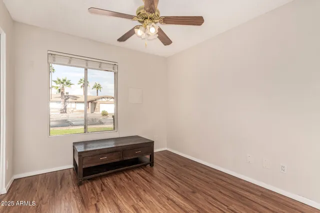 a view of a room with wooden floor and windows