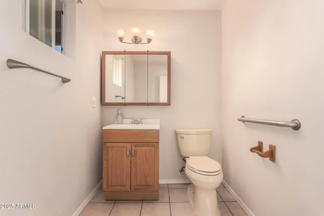 a bathroom with a toilet a sink and mirror
