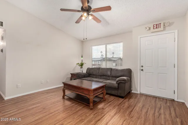 a living room with furniture and a wooden floor