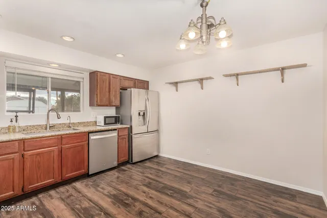 a kitchen with stainless steel appliances a refrigerator sink and cabinets