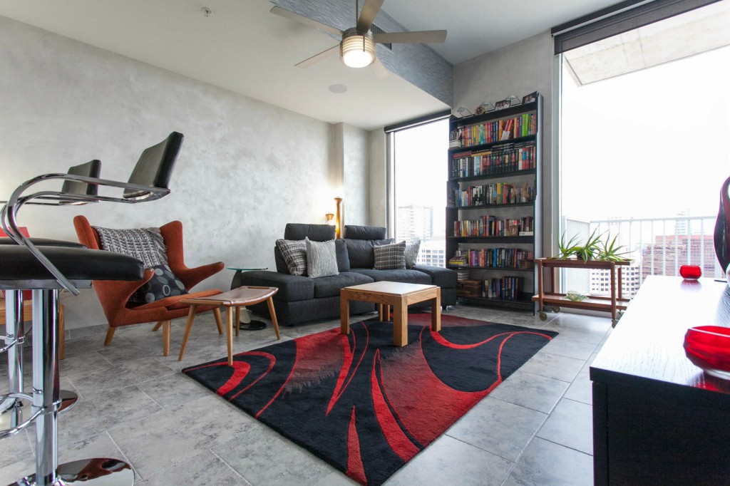 360 Nueces Street, Unit 1707 Austin, TX 78701 - Photo 1 of 1 a living room with furniture a rug and a large window
