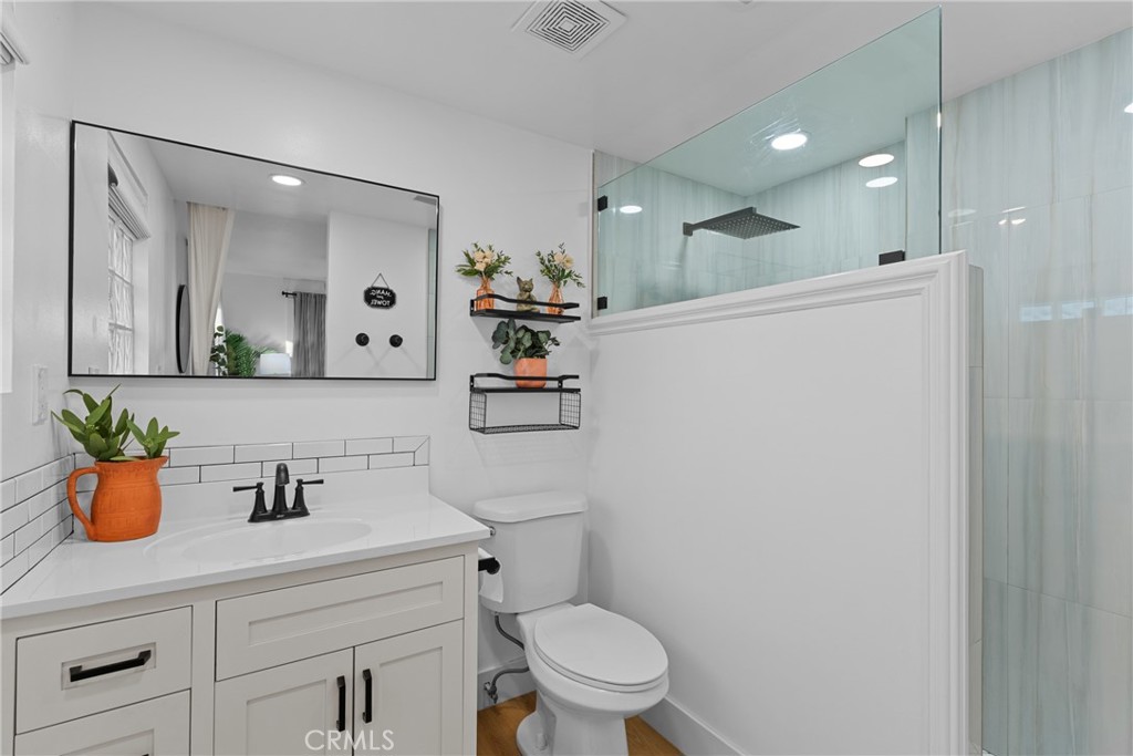 225 South Feldner Road Orange, CA 92868 - Photo 15 of 40 a bathroom with a sink a toilet a mirror and shower