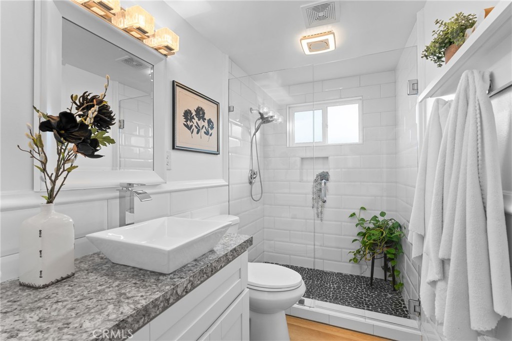 225 South Feldner Road Orange, CA 92868 - Photo 18 of 40 a bathroom with a granite countertop sink a toilet and a shower