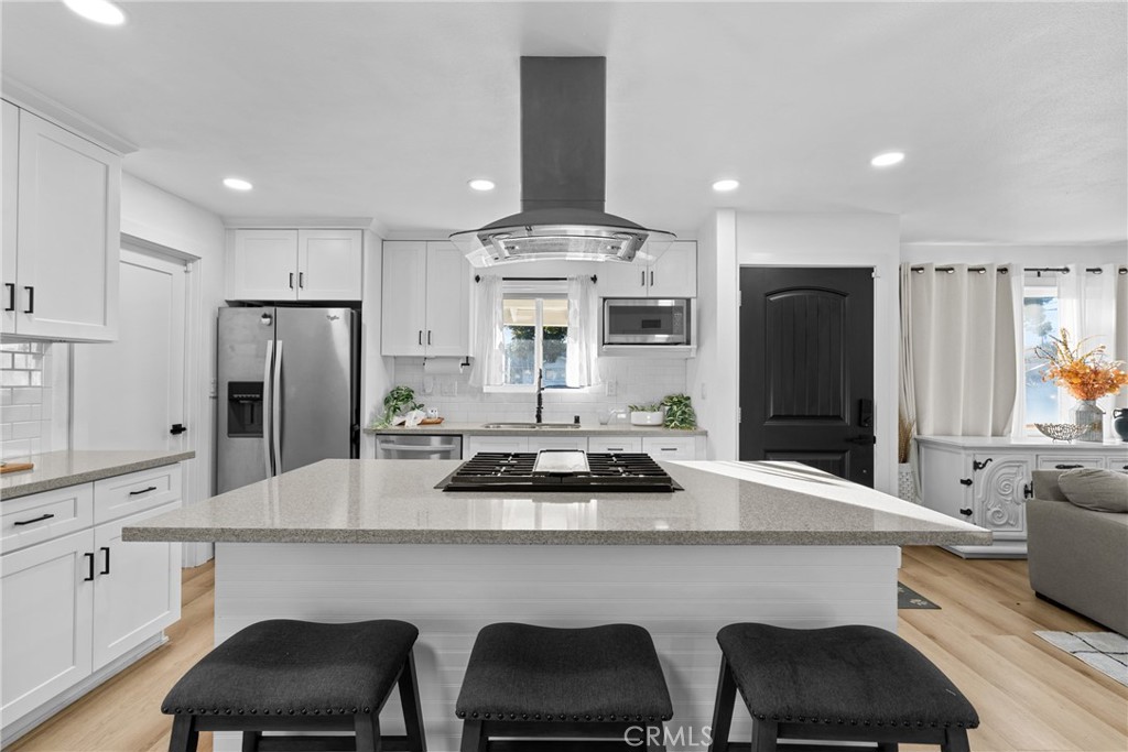 225 South Feldner Road Orange, CA 92868 - Photo 6 of 40 a kitchen with stainless steel appliances a dining table chairs refrigerator and stove
