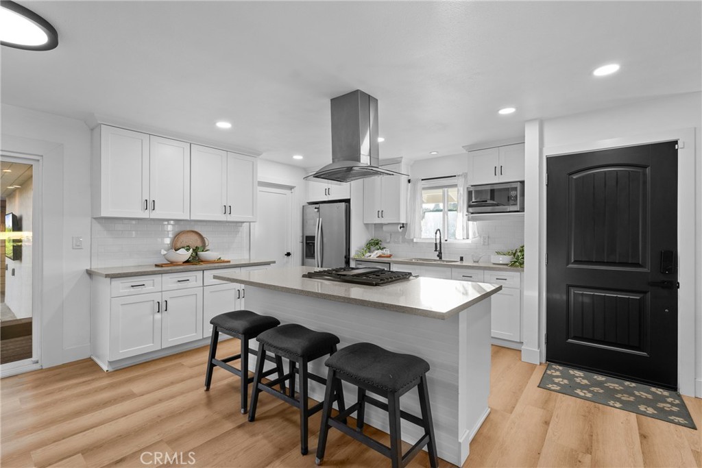 225 South Feldner Road Orange, CA 92868 - Photo 7 of 40 a kitchen with stainless steel appliances a sink stove refrigerator and cabinets