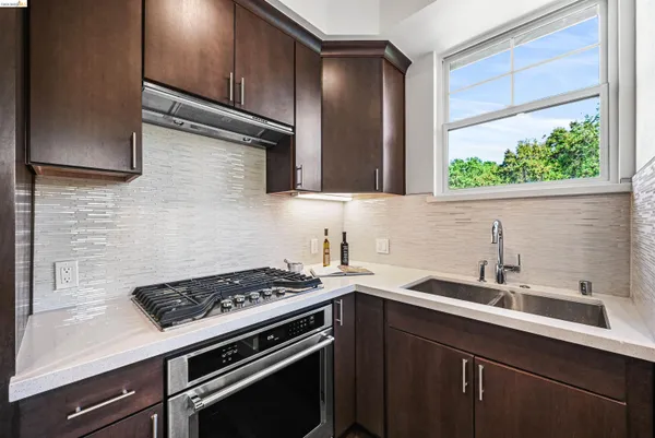 a kitchen with stainless steel appliances a refrigerator and a table