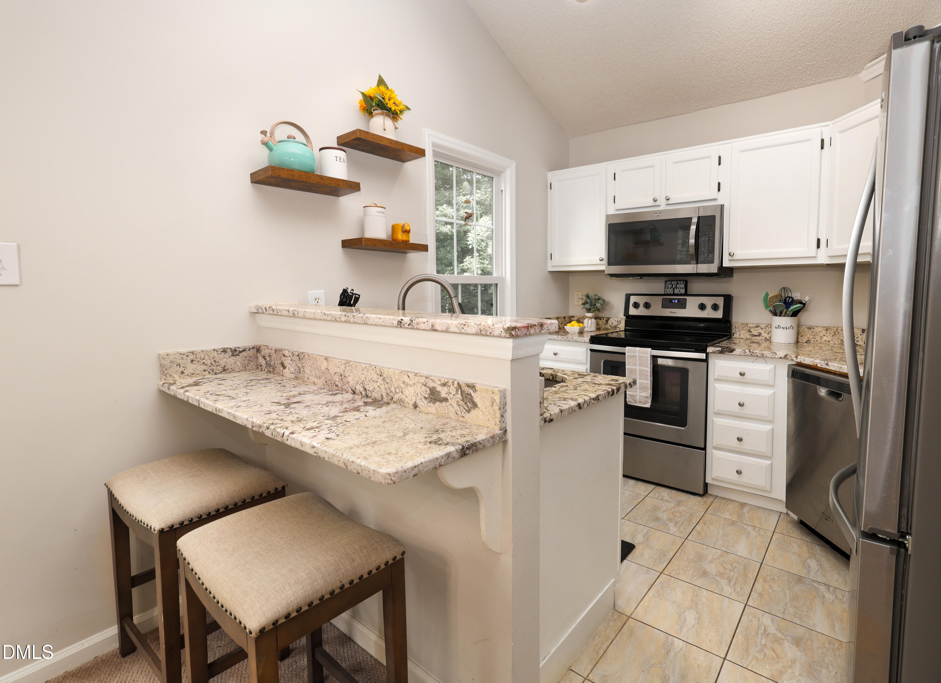 3011 Elk Ridge Road Durham, NC 27712 - Photo 12 of 68 a kitchen with stainless steel appliances a stove refrigerator sink and microwave