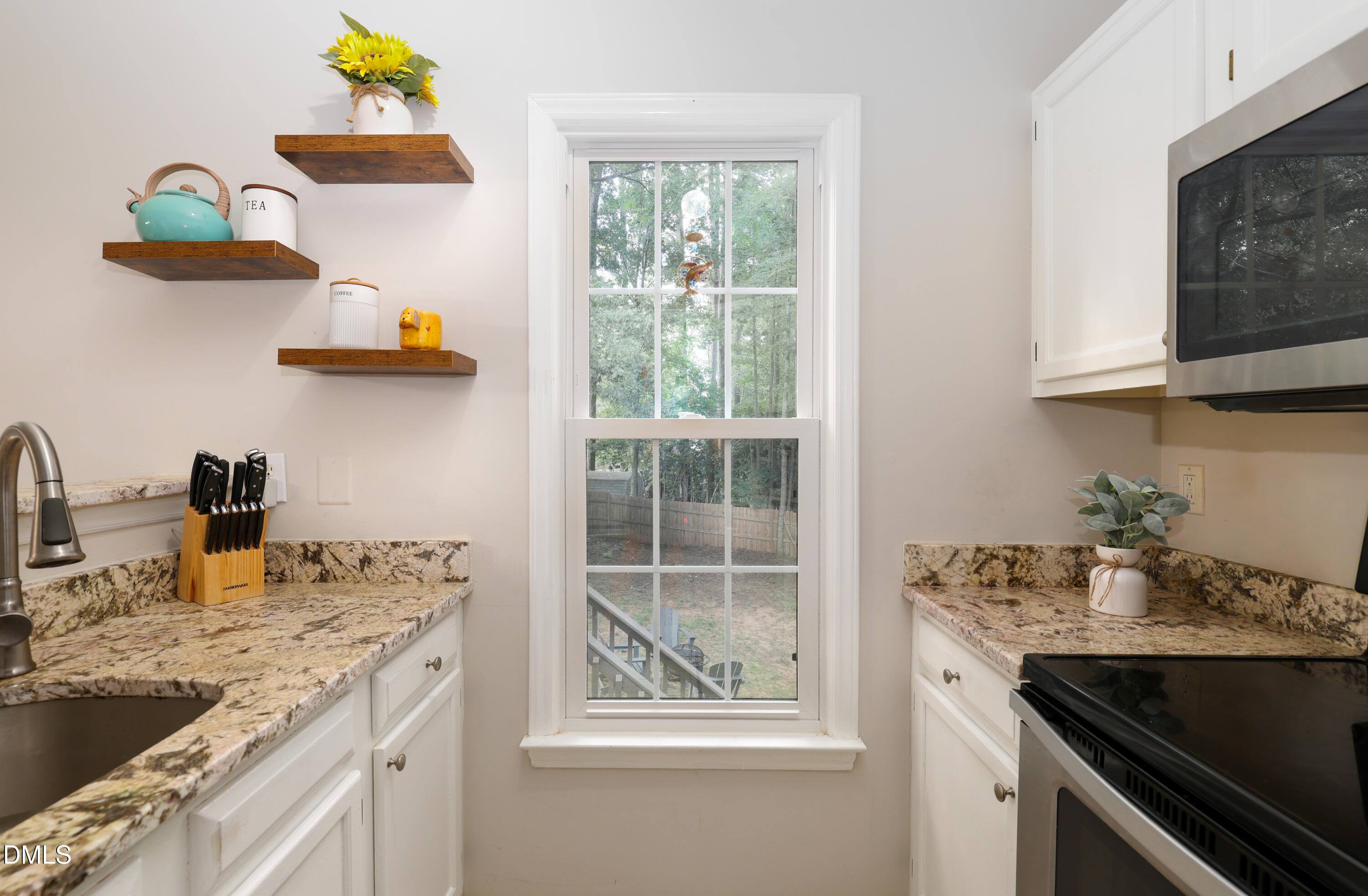 3011 Elk Ridge Road Durham, NC 27712 - Photo 18 of 68 a kitchen with a sink and a stove next to a window
