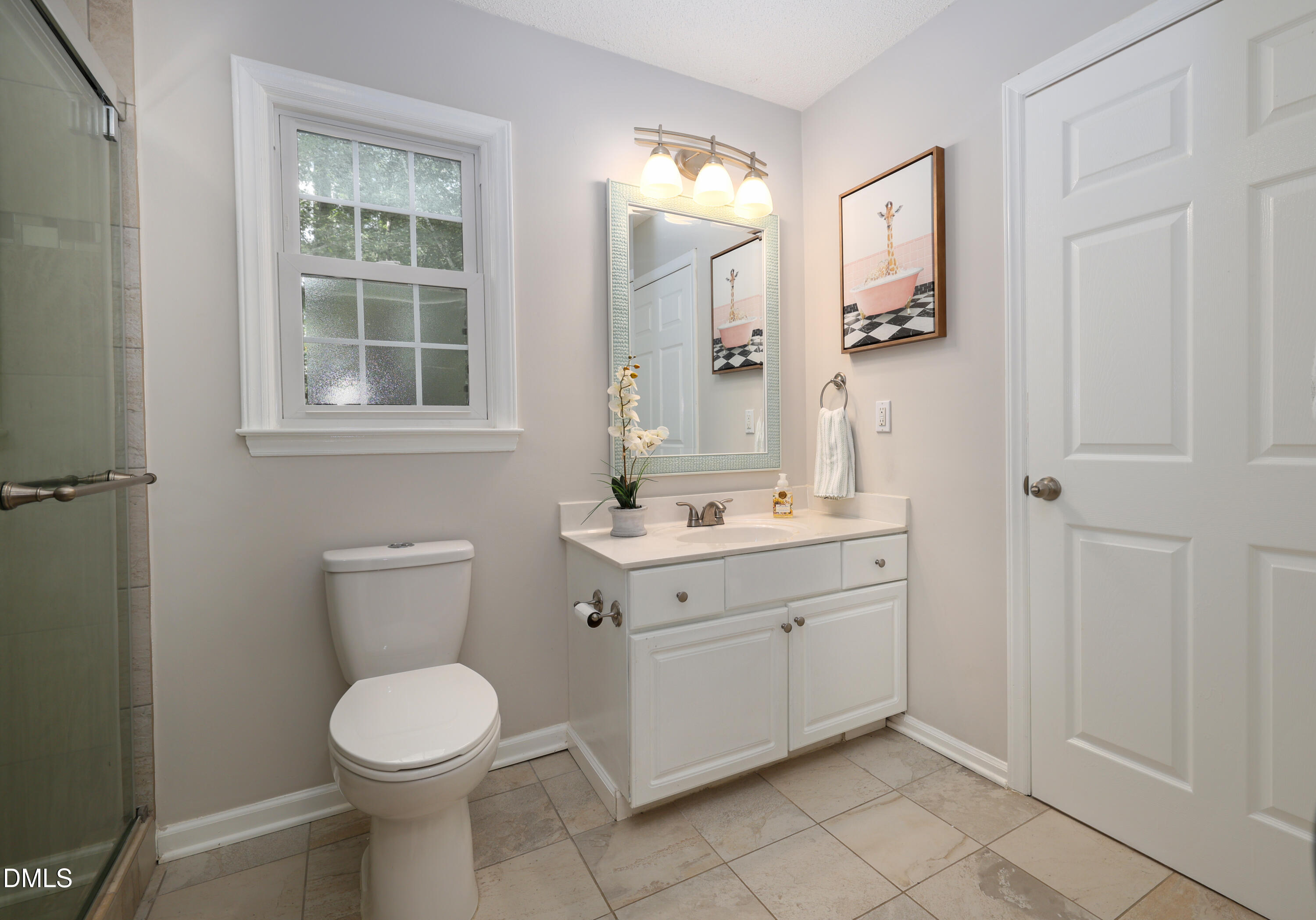 3011 Elk Ridge Road Durham, NC 27712 - Photo 32 of 68 a bathroom with a toilet sink and mirror