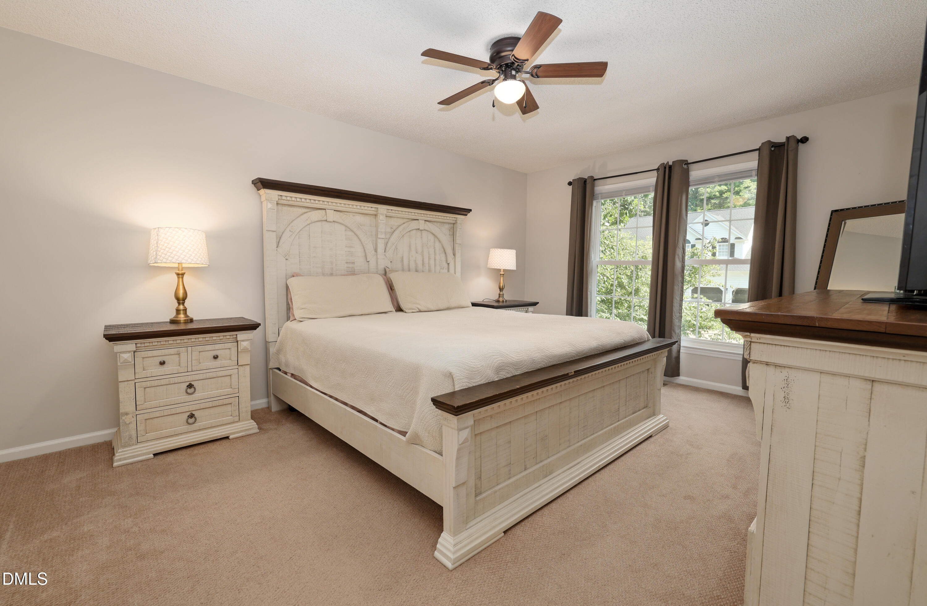 3011 Elk Ridge Road Durham, NC 27712 - Photo 37 of 68 a bedroom with a large bed and a chandelier
