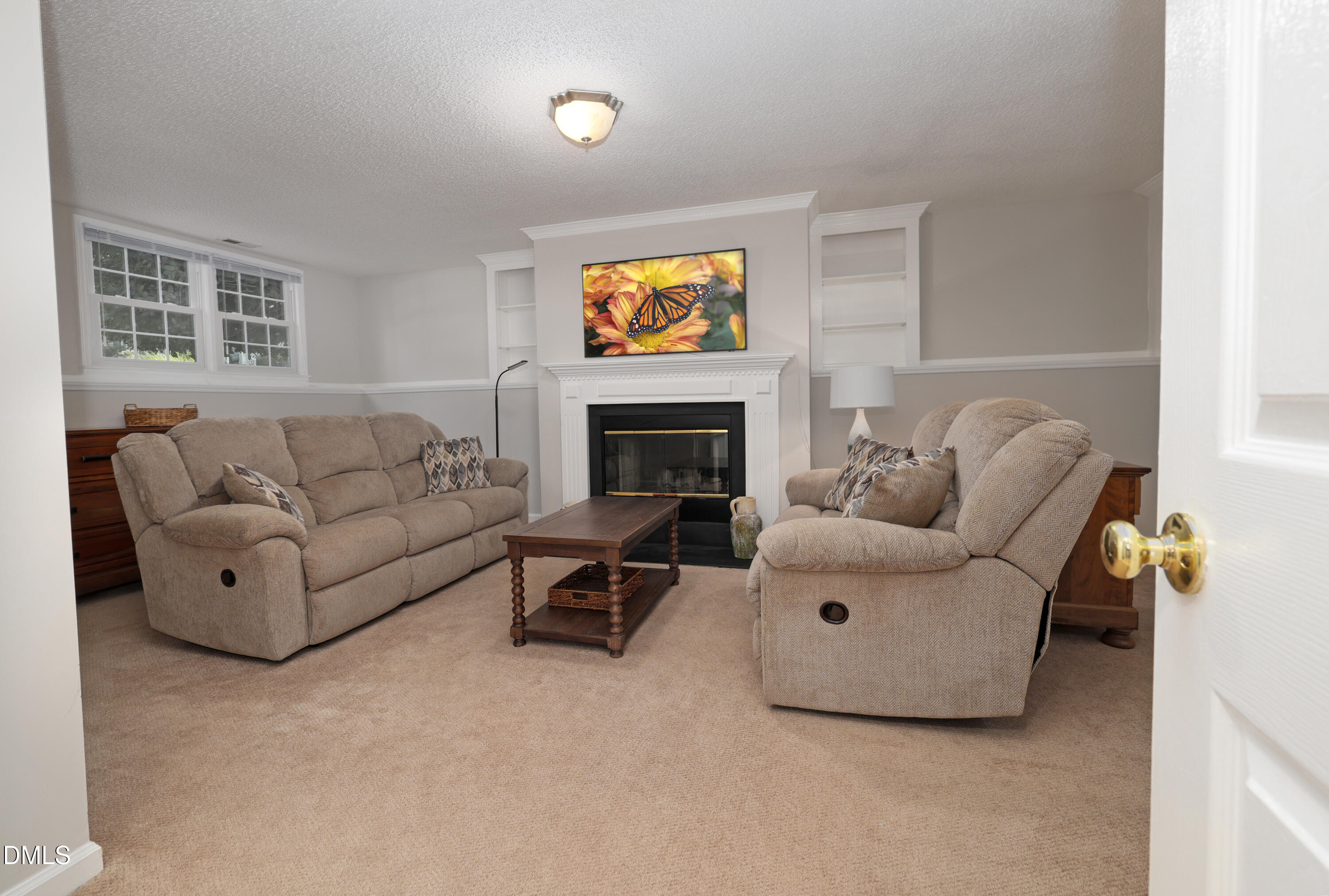3011 Elk Ridge Road Durham, NC 27712 - Photo 40 of 68 a living room with furniture a fireplace and a window