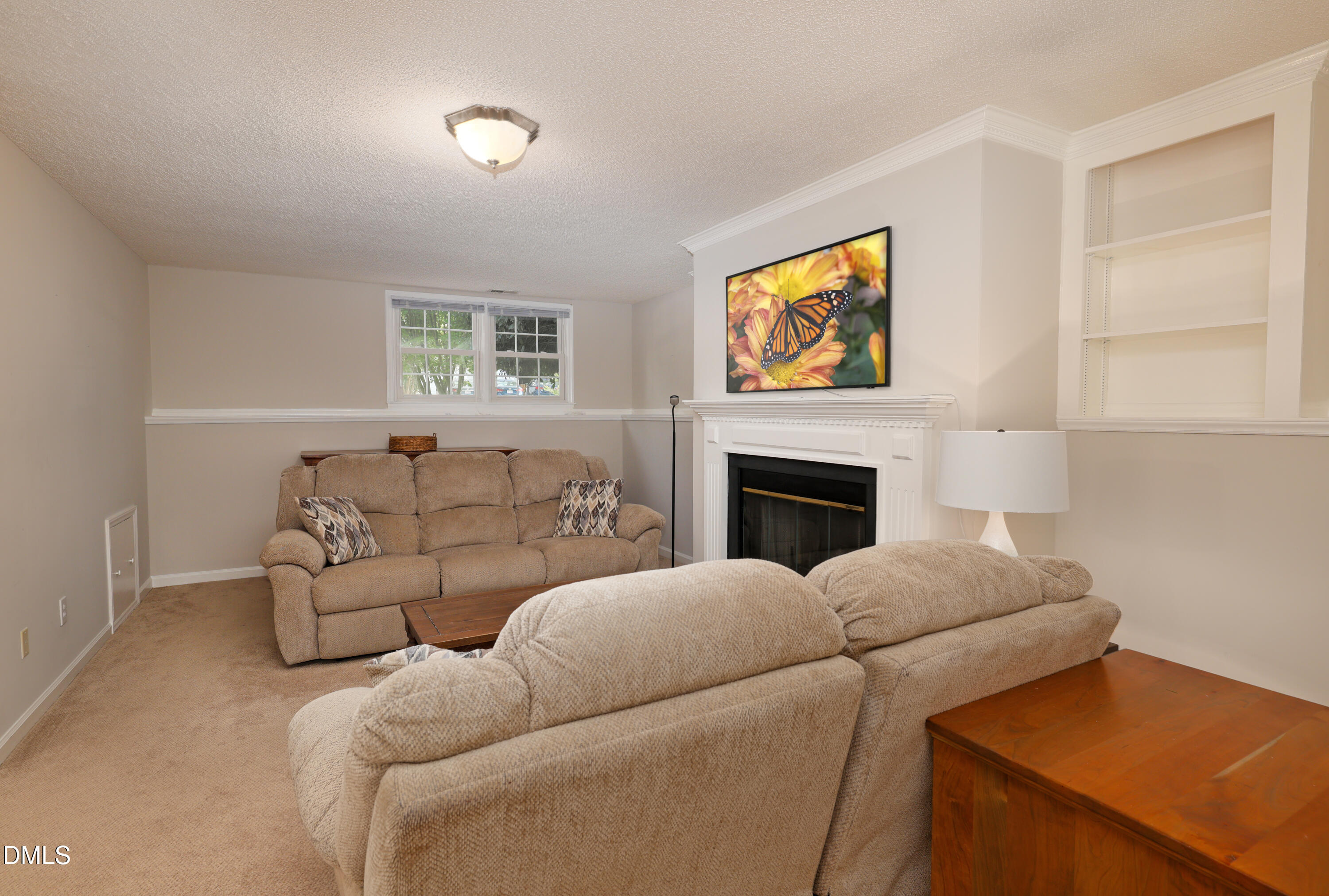 3011 Elk Ridge Road Durham, NC 27712 - Photo 41 of 68 a living room with furniture and a fireplace