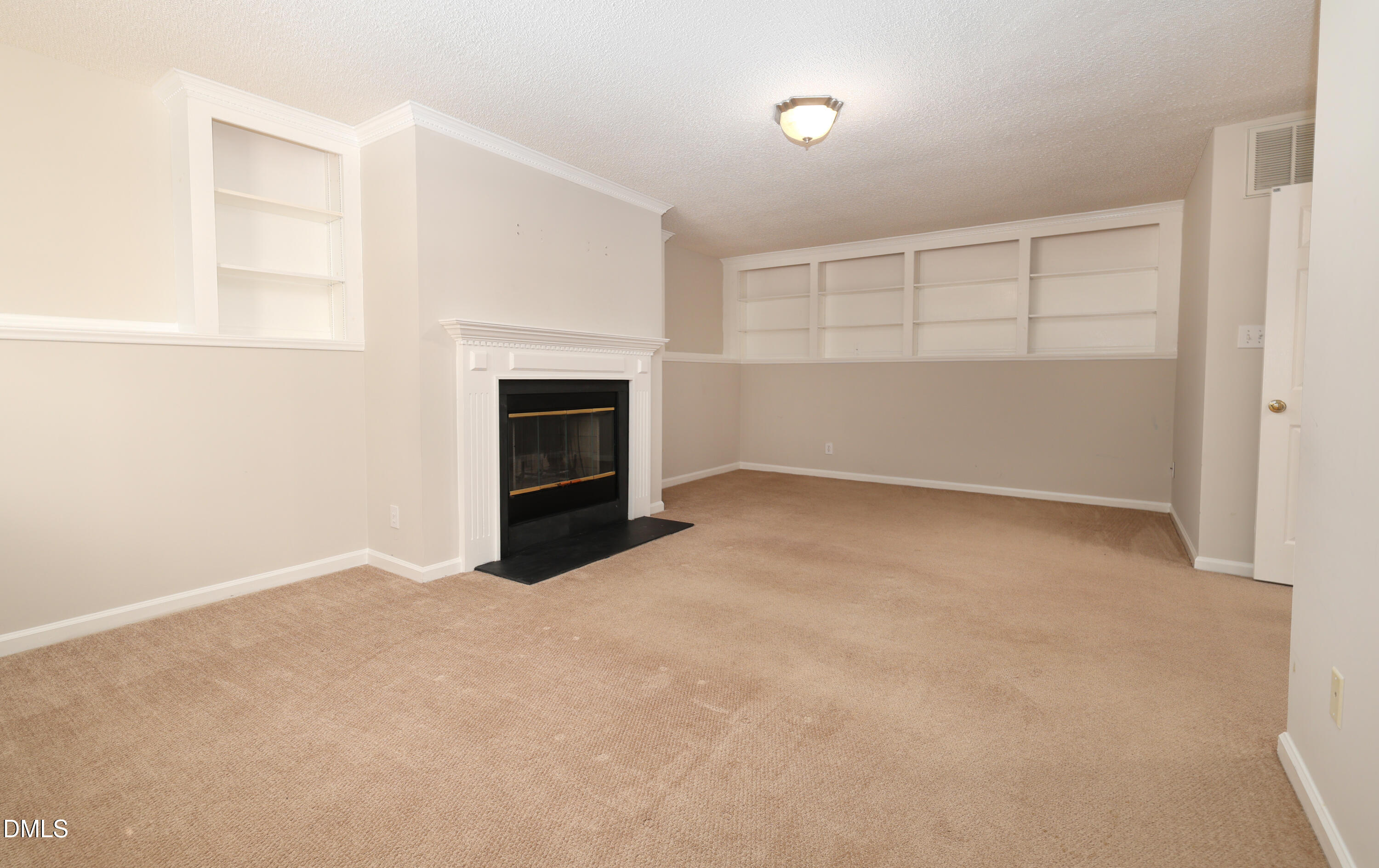 3011 Elk Ridge Road Durham, NC 27712 - Photo 44 of 68 an empty room with a fireplace