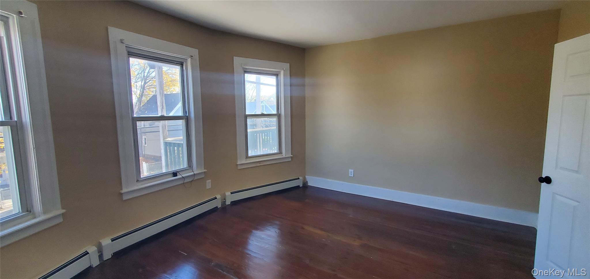 197 Winnikee Avenue, Unit 2 Poughkeepsie, NY 12601 - Photo 11 of 22 an empty room with wooden floor and windows