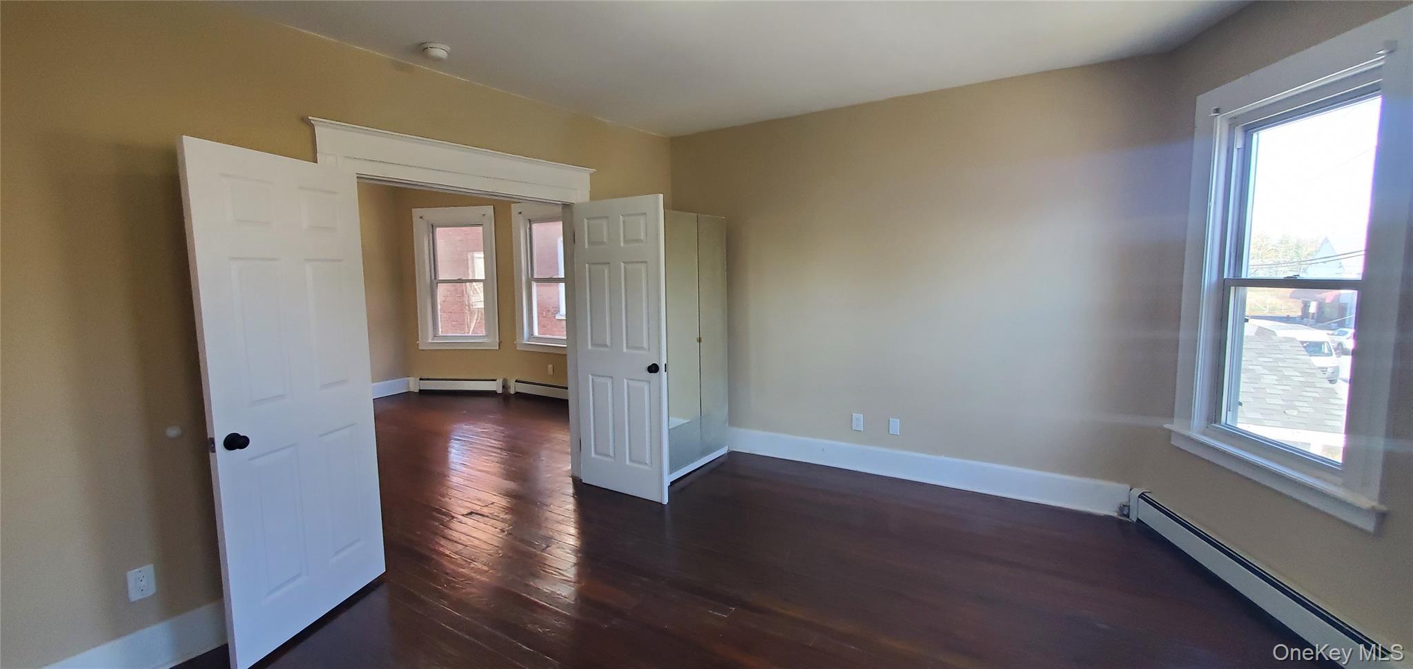 197 Winnikee Avenue, Unit 2 Poughkeepsie, NY 12601 - Photo 13 of 22 an empty room with wooden floor and windows
