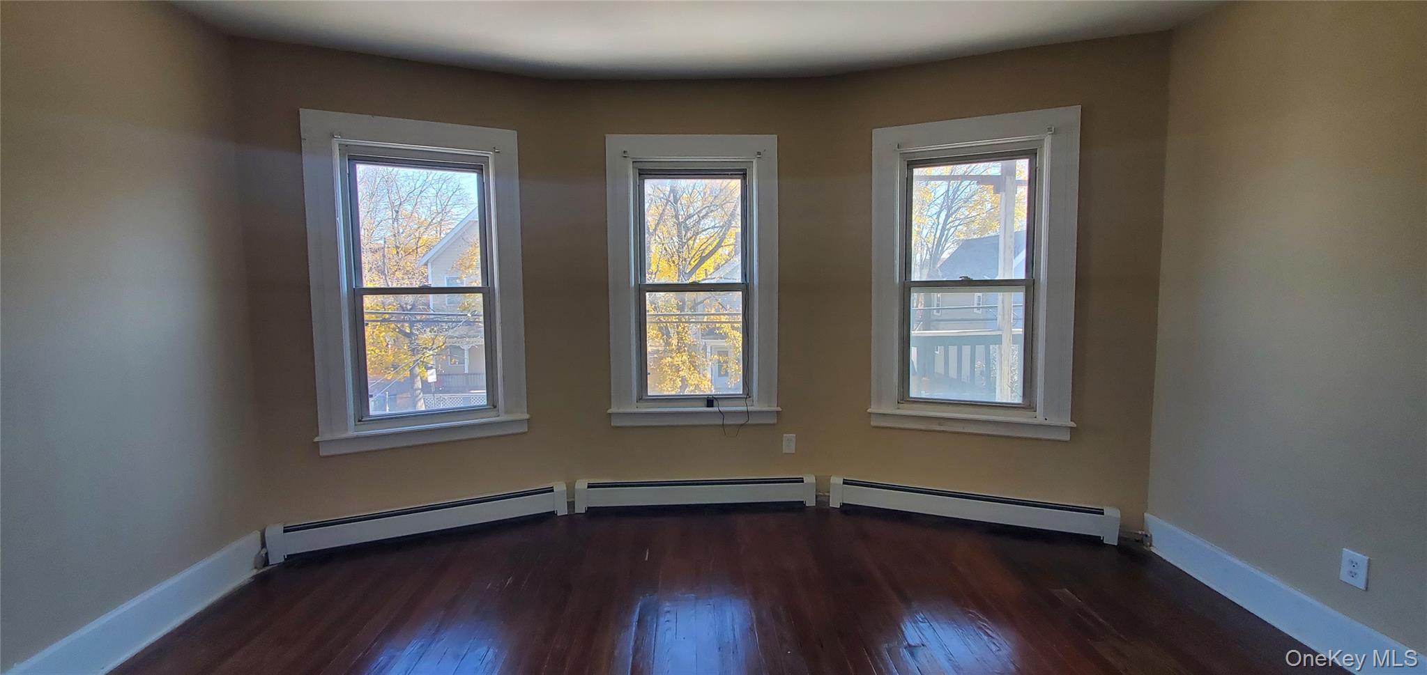197 Winnikee Avenue, Unit 2 Poughkeepsie, NY 12601 - Photo 14 of 22 an empty room with wooden floors and windows