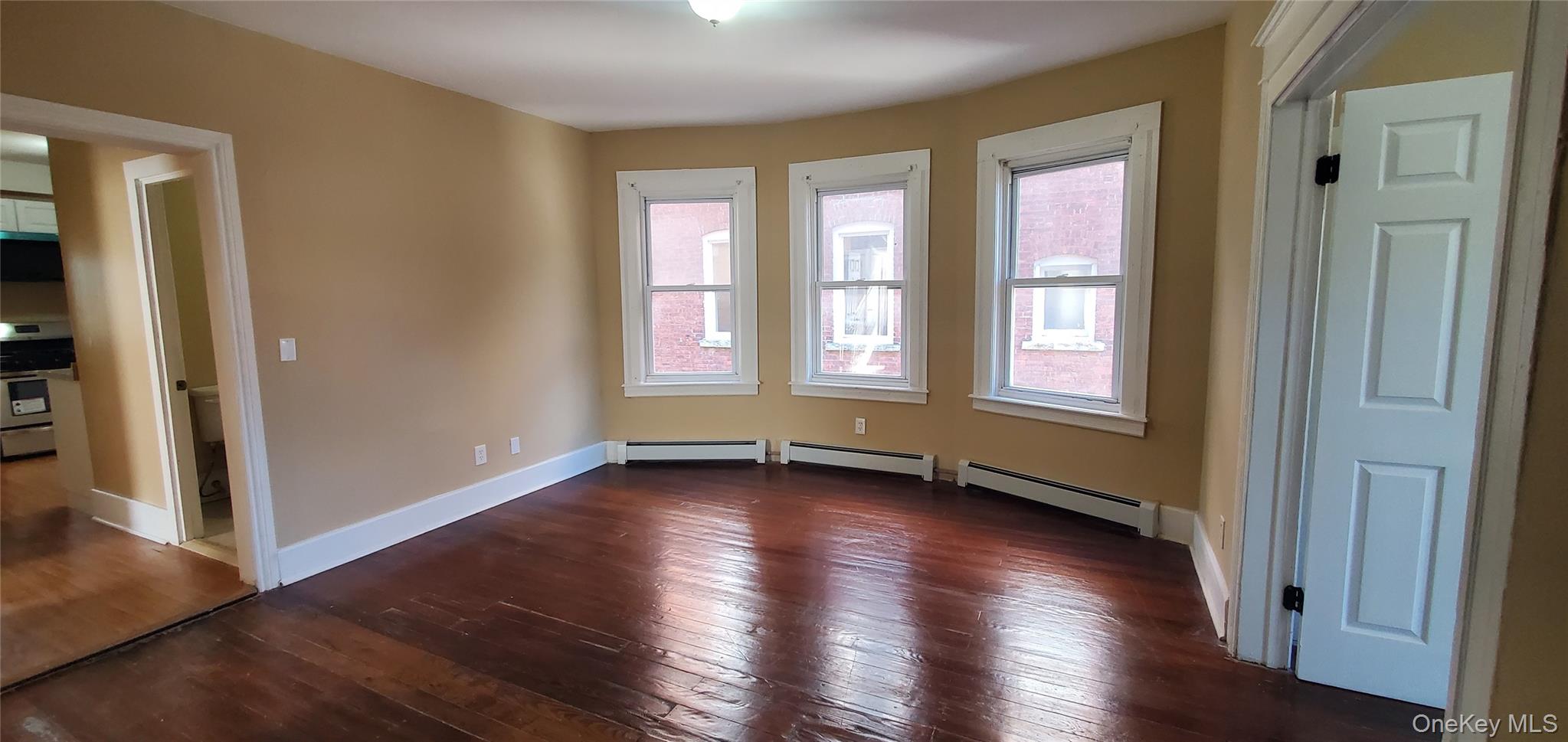 197 Winnikee Avenue, Unit 2 Poughkeepsie, NY 12601 - Photo 2 of 22 an empty room with wooden floor and windows