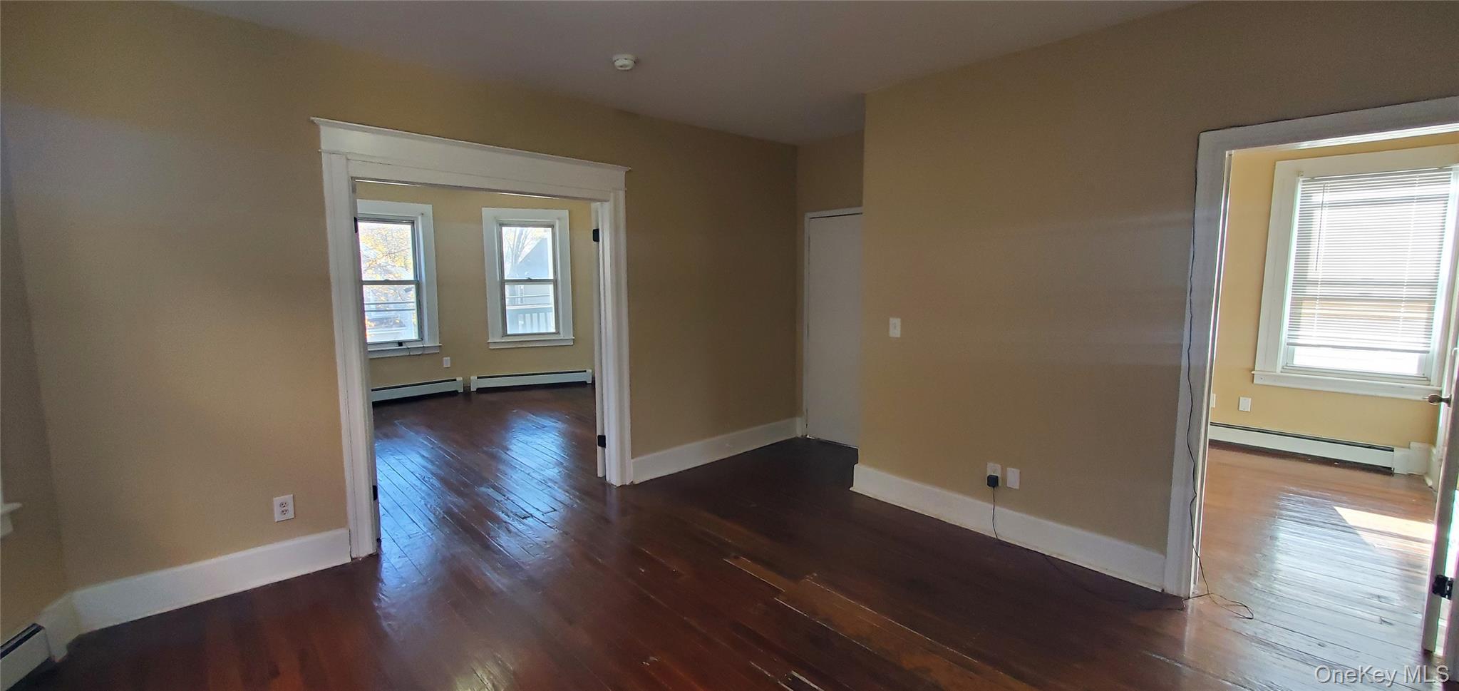 197 Winnikee Avenue, Unit 2 Poughkeepsie, NY 12601 - Photo 4 of 22 an empty room with wooden floor and windows