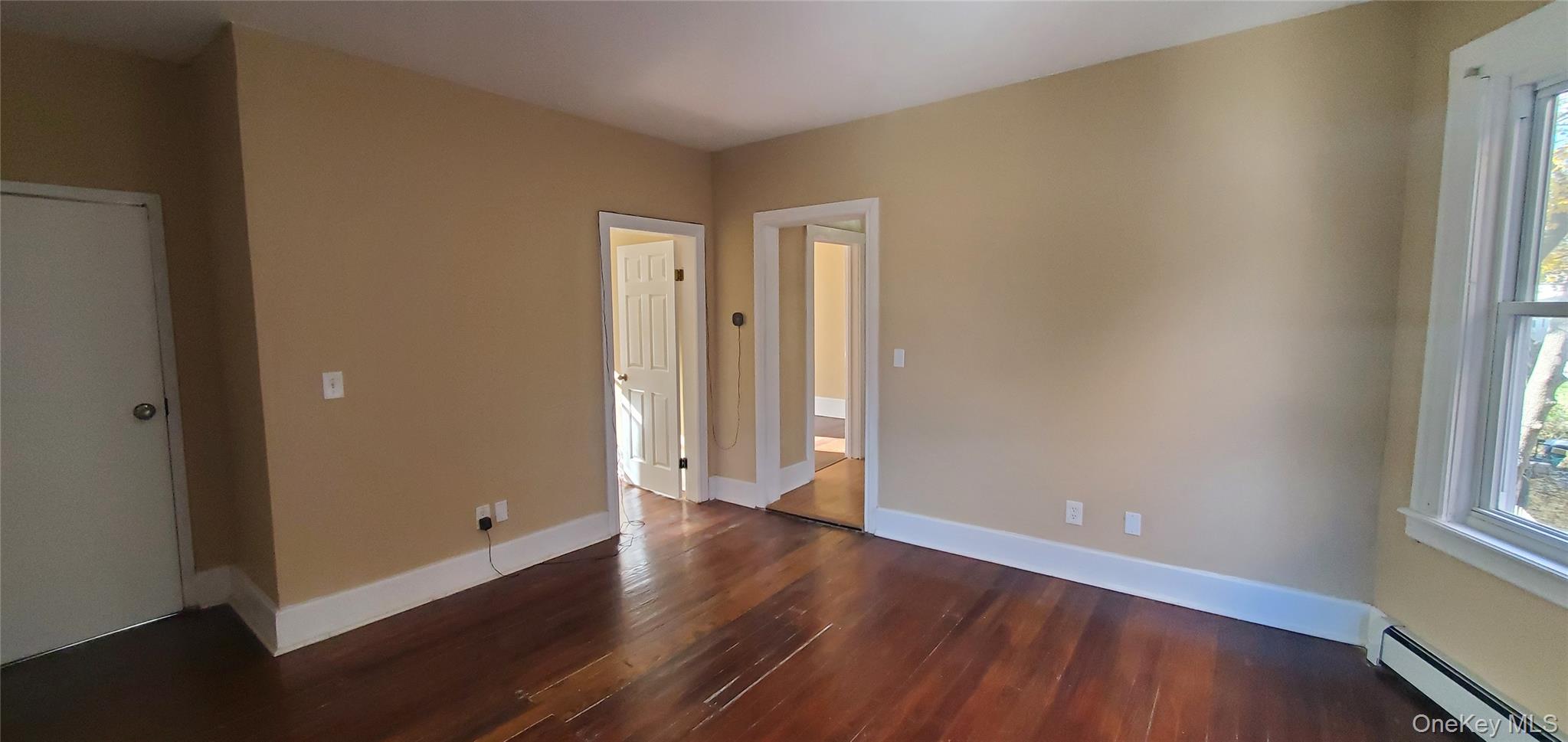197 Winnikee Avenue, Unit 2 Poughkeepsie, NY 12601 - Photo 5 of 22 an empty room with wooden floor and windows