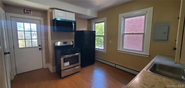 a kitchen with a stove a sink and a refrigerator