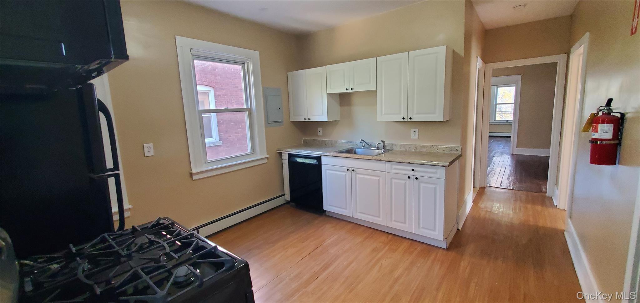 197 Winnikee Avenue, Unit 2 Poughkeepsie, NY 12601 - Photo 7 of 22 a kitchen with a stove a sink and a refrigerator