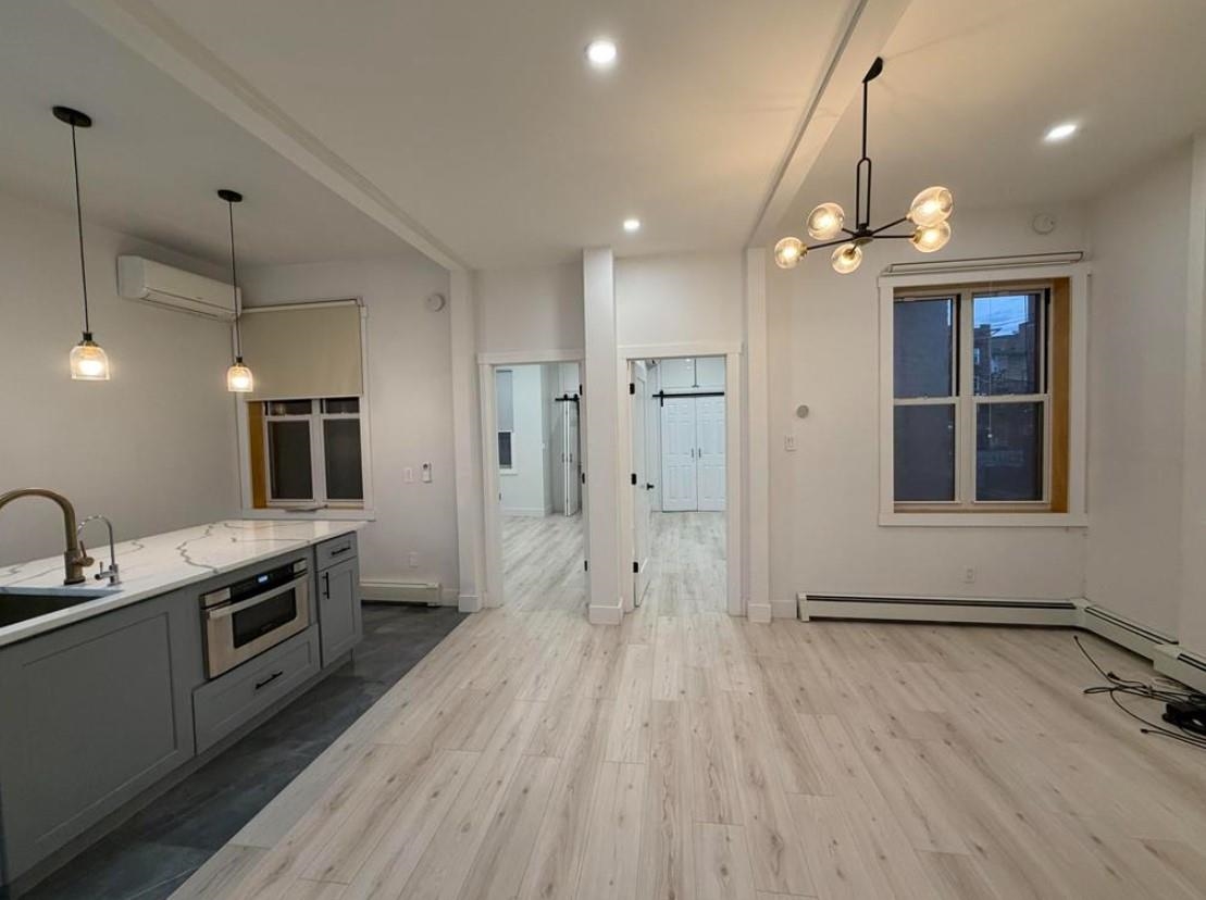 202 48th Street, Unit 3 Union City, NJ 07087 - Photo 1 of 10 a kitchen with stainless steel appliances granite countertop a stove a sink and a refrigerator