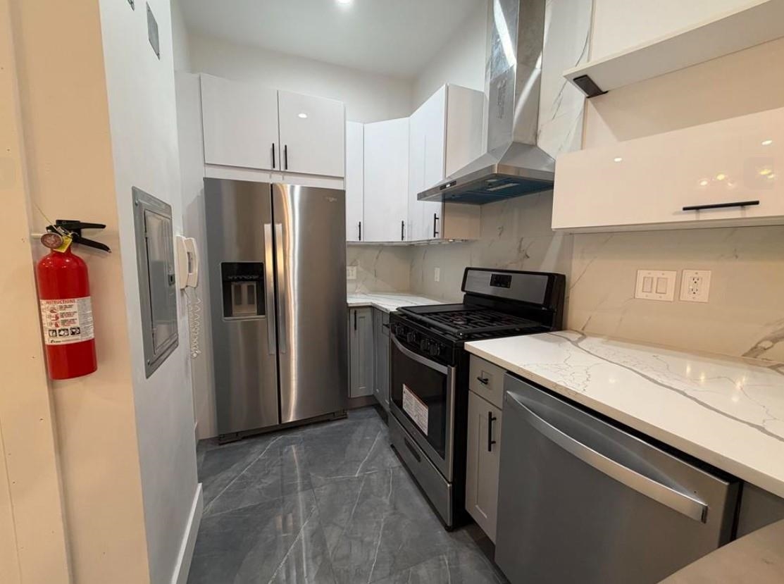 202 48th Street, Unit 3 Union City, NJ 07087 - Photo 4 of 10 a kitchen with stainless steel appliances granite countertop a refrigerator sink and stove