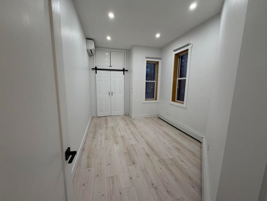 202 48th Street, Unit 3 Union City, NJ 07087 - Photo 7 of 10 a view of empty room with wooden floor and window