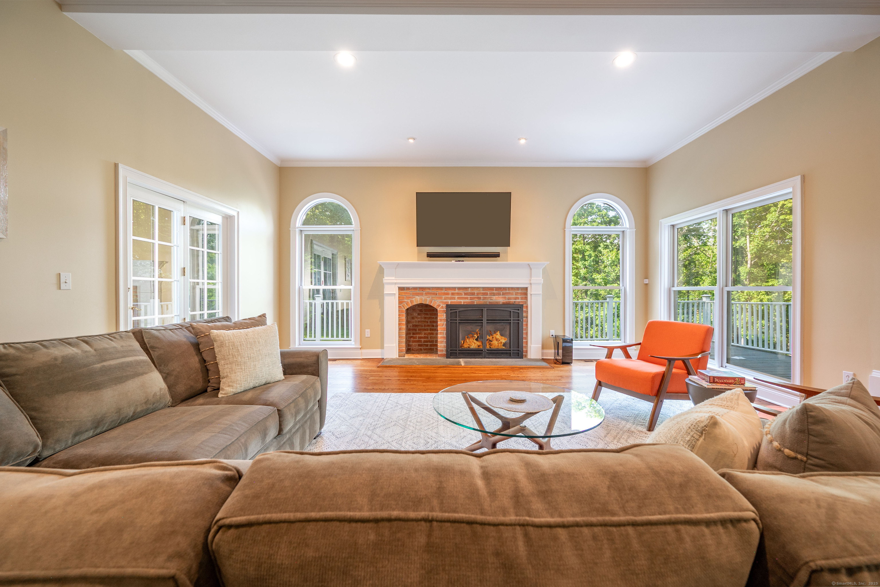 64 River Ford Road Brookfield, CT 06804 - Photo 11 of 28 a living room with furniture a flat screen tv and a fireplace
