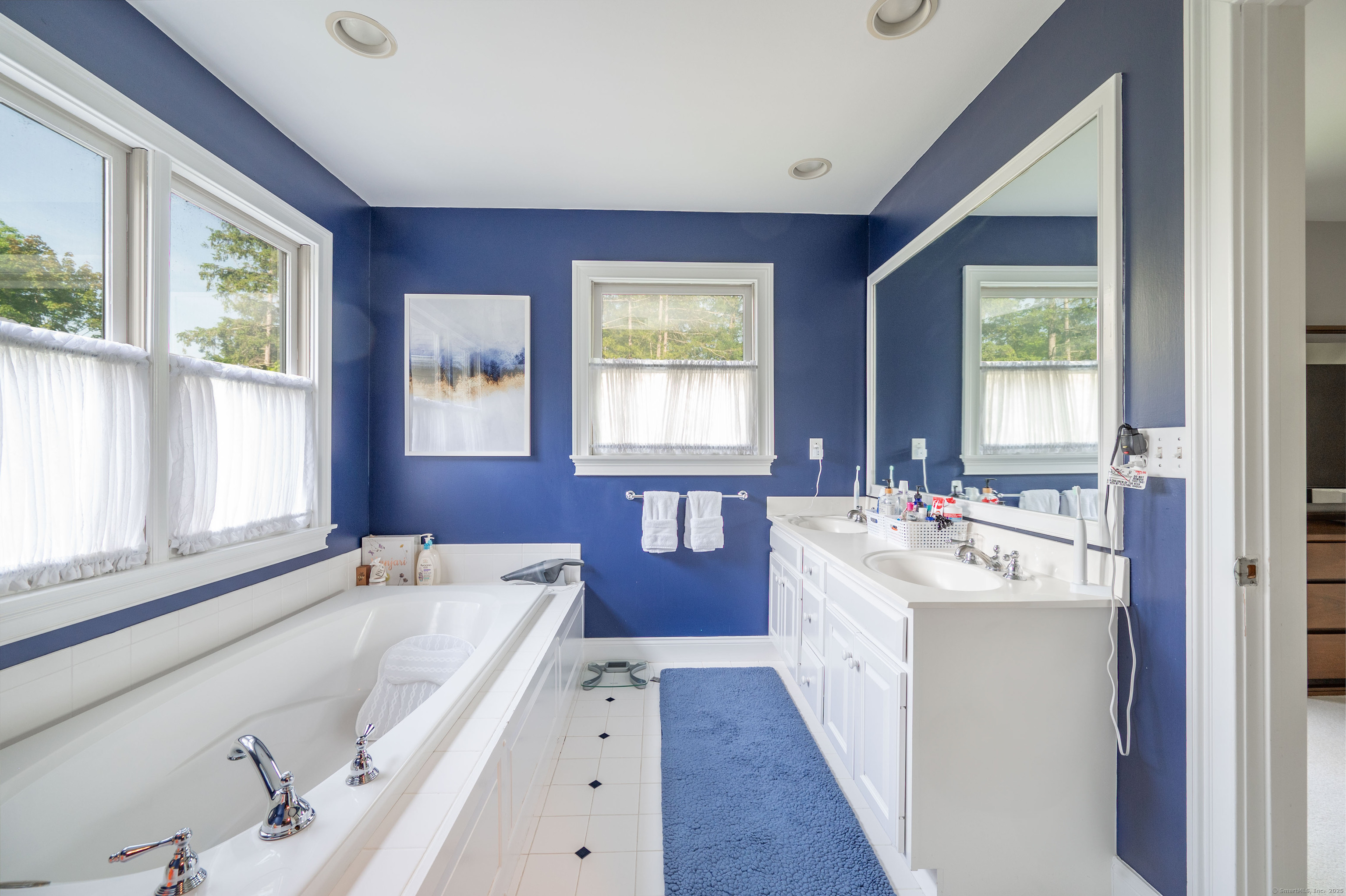 64 River Ford Road Brookfield, CT 06804 - Photo 20 of 28 a en suite bathroom with a double vanity sink large mirror and a bathtub