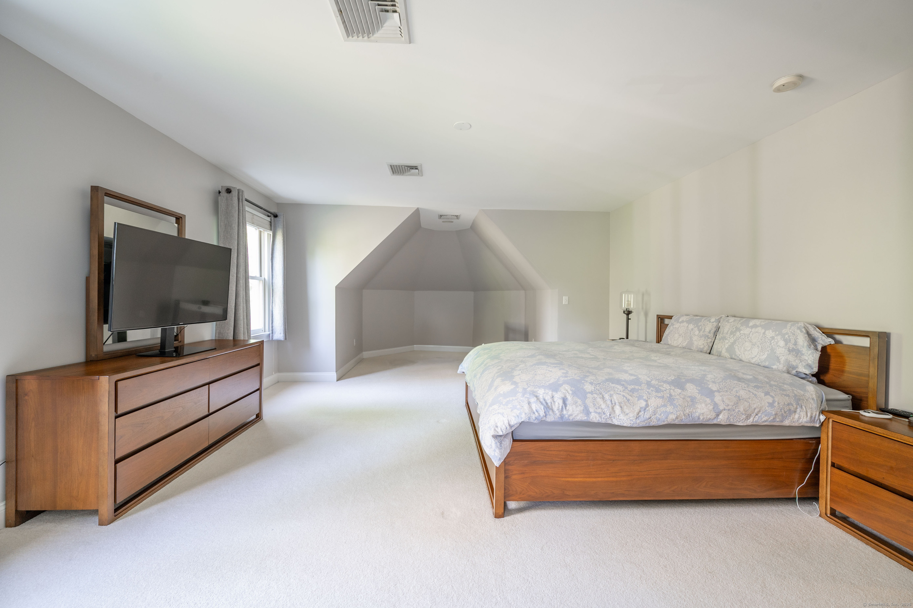 64 River Ford Road Brookfield, CT 06804 - Photo 21 of 28 a spacious bedroom with a bed and a flat screen tv